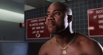 Movie still from “Jerry Maguire” (1996), directed by Cameron Crowe – A man with a beard is looking at the camera; Close Up shot, Low angle