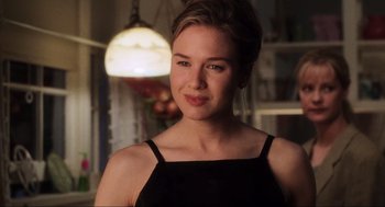 Movie still from “Jerry Maguire” (1996), directed by Cameron Crowe – A beautiful young lady wearing a black top; Close Up shot, Over the shoulder angle