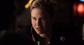 Movie still from “Jerry Maguire” (1996), directed by Cameron Crowe – A person wearing headphones; Close Up shot, Over the shoulder angle