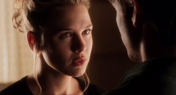 Movie still from “Jerry Maguire” (1996), directed by Cameron Crowe – A young woman looking at the camera while a man looks at her face; Close Up shot, Over the shoulder angle