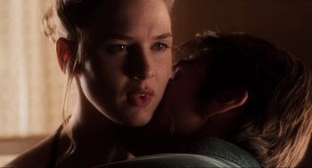 Movie still from “Jerry Maguire” (1996), directed by Cameron Crowe – A young woman is kissing a young man on the cheek; Close Up shot, Over the shoulder angle
