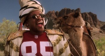 Movie still from “Jerry Maguire” (1996), directed by Cameron Crowe – A man wearing a hat and a jacket and a camel; Close Up shot, Low angle