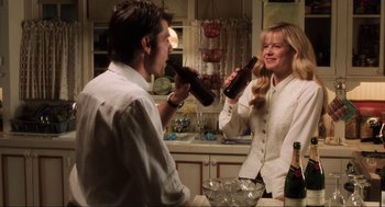 Movie still from “Jerry Maguire” (1996), directed by Cameron Crowe – A man and a woman drinking beer in a kitchen; Medium shot, Over the shoulder angle
