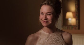 Movie still from “Jerry Maguire” (1996), directed by Cameron Crowe – A beautiful young lady smiling for the camera; Close Up shot, Over the shoulder angle