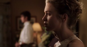 Movie still from “Jerry Maguire” (1996), directed by Cameron Crowe – A young woman is listening intently to music while a young man watches; Close Up shot, Over the shoulder angle