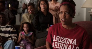 Movie still from “Jerry Maguire” (1996), directed by Cameron Crowe – A group of people sitting in front of a woman; Medium shot, Over the shoulder angle