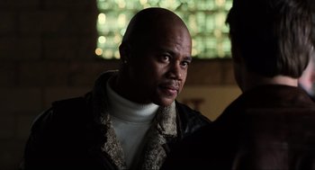 Movie still from “Jerry Maguire” (1996), directed by Cameron Crowe – A man with a beard is looking into the distance; Close Up shot, Over the shoulder angle