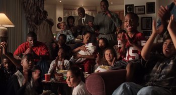 Movie still from “Jerry Maguire” (1996), directed by Cameron Crowe – A large group of people watching a football game; Wide shot, High angle