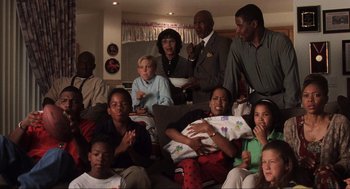 Movie still from “Jerry Maguire” (1996), directed by Cameron Crowe – A group of people sitting on top of a couch; Wide shot, High angle