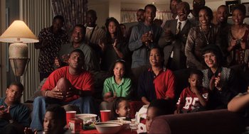 Movie still from “Jerry Maguire” (1996), directed by Cameron Crowe – A group of people sitting around a table with drinks; Medium shot, High angle