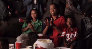 Movie still from “Jerry Maguire” (1996), directed by Cameron Crowe – A group of people sitting around a table; Medium shot, High angle