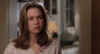 Movie still from “Jerry Maguire” (1996), directed by Cameron Crowe – A woman with long brown hair wearing a white shirt; Close Up shot, Over the shoulder angle