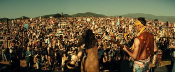 Movie still from “Jesus Revolution” (2023), directed by Brent McCorkle – A crowd of people at an outdoor concert; Extreme Wide shot, High angle