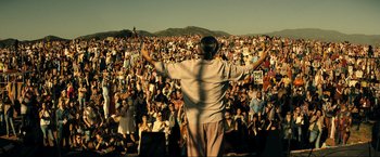 Movie still from “Jesus Revolution” (2023), directed by Brent McCorkle – A man standing in front of a large crowd of people; Extreme Wide shot, High angle