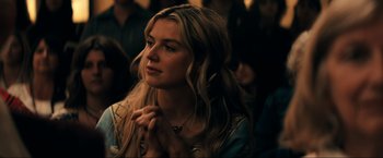 Movie still from “Jesus Revolution” (2023), directed by Brent McCorkle – A beautiful young woman with long blonde hair; Close Up shot, Over the shoulder angle