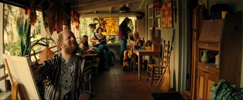 Movie still from “Jesus Revolution” (2023), directed by Brent McCorkle – A group of people sitting at a table in a restaurant; Wide shot, Over the shoulder angle