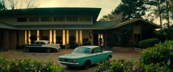 Movie still from “Jesus Revolution” (2023), directed by Brent McCorkle – An old car parked in front of a house; Extreme Wide shot, Low angle