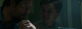 Movie still from “Joe Bell” (2020), directed by Reinaldo Marcus Green – A man and a boy are smiling at each other; Close Up shot, Over the shoulder angle