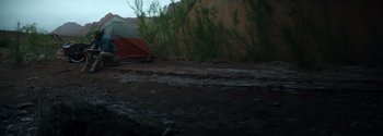 Movie still from “Joe Bell” (2020), directed by Reinaldo Marcus Green – A red and white tent in the middle of a dirt field; Wide shot, Low angle