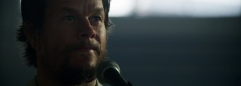 Movie still from “Joe Bell” (2020), directed by Reinaldo Marcus Green – A person holding a microphone; Close Up shot, Low angle