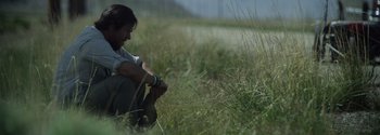 Movie still from “Joe Bell” (2020), directed by Reinaldo Marcus Green – A person sitting in a field with a dog; Close Up shot, Low angle
