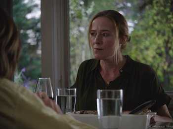 Movie still from “John and the Hole” (2021), directed by Pascual Sisto – A woman sitting at a table with a glass of water; Close Up shot, Over the shoulder angle