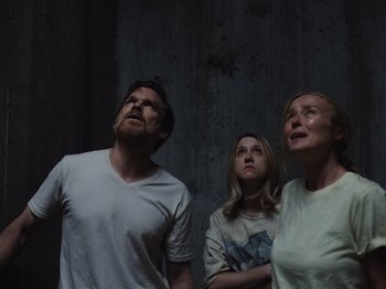 Movie still from “John and the Hole” (2021), directed by Pascual Sisto – A group of people standing next to each other in a room; Medium shot, Low angle