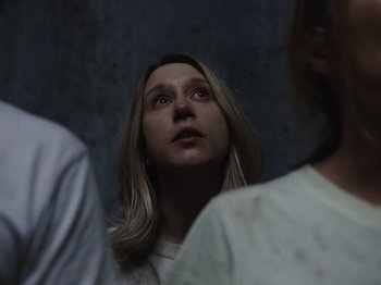 Movie still from “John and the Hole” (2021), directed by Pascual Sisto – A woman with long blonde hair looking up at the sky; Close Up shot, Over the shoulder angle
