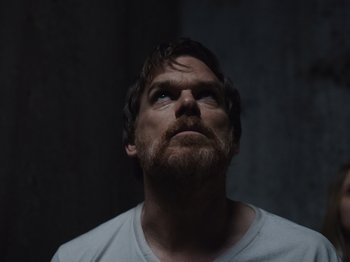 Movie still from “John and the Hole” (2021), directed by Pascual Sisto – A man with a goatee looking up into the sky; Close Up shot, Low angle