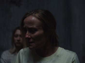 Movie still from “John and the Hole” (2021), directed by Pascual Sisto – A woman in a white t - shirt is standing next to another woman in a white t - shirt; Close Up shot, Over the shoulder angle