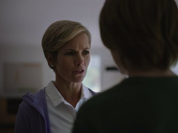 Movie still from “John and the Hole” (2021), directed by Pascual Sisto – A woman talking to another woman in a room; Close Up shot, Over the shoulder angle