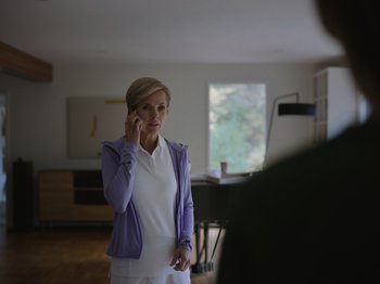 Movie still from “John and the Hole” (2021), directed by Pascual Sisto – A woman is talking on a cell phone in front of a mirror; Medium shot, Over the shoulder angle