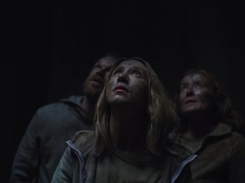 Movie still from “John and the Hole” (2021), directed by Pascual Sisto – A group of people standing next to each other in the dark; Medium shot, Low angle