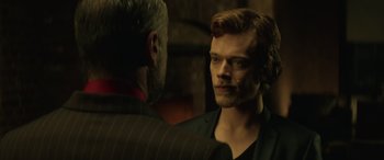 Movie still from “John Wick” (2014), directed by Chad Stahelski – A man in a suit is looking at a man in a suit; Close Up shot, Over the shoulder angle