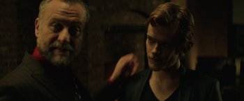 Movie still from “John Wick” (2014), directed by Chad Stahelski – A man in a black shirt and a man in a black jacket; Close Up shot, Over the shoulder angle