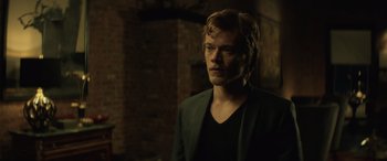 Movie still from “John Wick” (2014), directed by Chad Stahelski – A man in a black shirt and a black jacket; Close Up shot, Over the shoulder angle