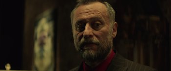 Movie still from “John Wick” (2014), directed by Chad Stahelski – A person wearing a suit and tie; Close Up shot, Low angle