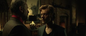 Movie still from “John Wick” (2014), directed by Chad Stahelski – A man with long hair and a goatee stares at another man with a beard; Close Up shot, Over the shoulder angle
