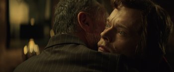 Movie still from “John Wick” (2014), directed by Chad Stahelski – A man in a suit hugging another man in a suit; Close Up shot, Over the shoulder angle