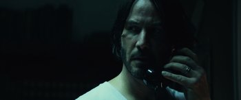 Movie still from “John Wick” (2014), directed by Chad Stahelski – A man in a white shirt talking on a phone; Close Up shot, Over the shoulder angle