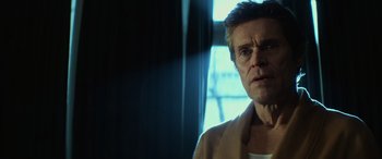 Movie still from “John Wick” (2014), directed by Chad Stahelski – A person wearing a jacket near a window; Close Up shot, Low angle