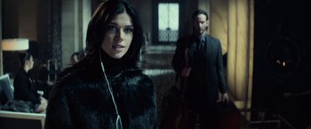 Movie still from “John Wick” (2014), directed by Chad Stahelski – A man and a woman standing next to each other; Close Up shot, Over the shoulder angle