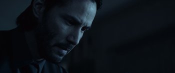 Movie still from “John Wick” (2014), directed by Chad Stahelski – A man's face in the dark; Close Up shot, Over the shoulder angle