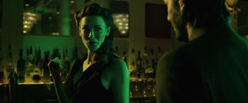 Movie still from “John Wick” (2014), directed by Chad Stahelski – A woman in a black dress standing next to a man; Close Up shot, Over the shoulder angle