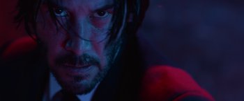 Movie still from “John Wick” (2014), directed by Chad Stahelski – A man's face in a dark room; Close Up shot, Low angle