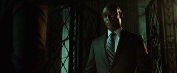 Movie still from “John Wick” (2014), directed by Chad Stahelski – A man in a suit and tie standing in front of a window; Close Up shot, Low angle