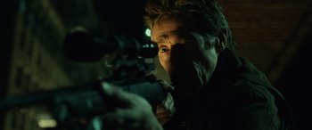 Movie still from “John Wick” (2014), directed by Chad Stahelski – A man with a gun looking into the distance; Extreme Close Up shot, Low angle