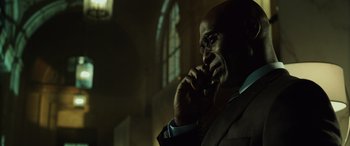 Movie still from “John Wick” (2014), directed by Chad Stahelski – A man in a suit is talking on a cell phone; Close Up shot, Low angle