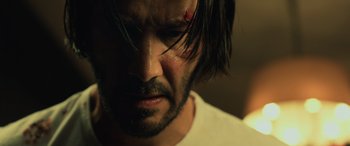 Movie still from “John Wick” (2014), directed by Chad Stahelski – A person with a knife on his face; Close Up shot, Low angle
