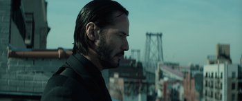 Movie still from “John Wick” (2014), directed by Chad Stahelski – A man with long hair and a beard looking off into the distance; Close Up shot, Low angle